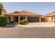 Charming single-story home featuring a two-car garage and a well-manicured front yard at 16577 W Garfield St, Goodyear, AZ 85338