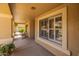 Inviting front porch with neutral finishes, offering an airy and welcoming entryway at 16577 W Garfield St, Goodyear, AZ 85338