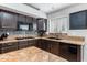 Close-up on the kitchen with granite countertops, stainless steel appliances, and stylish backsplash at 16577 W Garfield St, Goodyear, AZ 85338