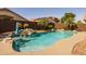 Backyard pool featuring a rock waterfall, and blue accent umbrella at 16577 W Garfield St, Goodyear, AZ 85338