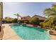 Backyard boasts a gorgeous pool surrounded by lush greenery and ample space for relaxation at 16577 W Garfield St, Goodyear, AZ 85338