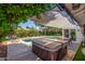 Backyard featuring a pool, hot tub, patio area, and mature landscaping at 1708 E Impala Ave, Mesa, AZ 85204