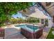 Backyard featuring a pool, hot tub, patio area, and mature landscaping at 1708 E Impala Ave, Mesa, AZ 85204