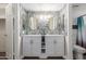Bathroom featuring a double sink vanity with modern fixtures and decorative mirrors at 1708 E Impala Ave, Mesa, AZ 85204