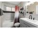 Bathroom with white tile, gray vanity, and modern fixtures at 1708 E Impala Ave, Mesa, AZ 85204