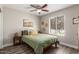 Comfortable bedroom with ceiling fan, wood-look flooring, and a bright window view at 1708 E Impala Ave, Mesa, AZ 85204