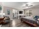 Spacious bedroom with a ceiling fan, ensuite bathroom, and a view from the window at 1708 E Impala Ave, Mesa, AZ 85204