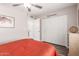 Cozy bedroom with a ceiling fan, closet doors, and a warm ambiance at 1708 E Impala Ave, Mesa, AZ 85204