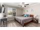 Bright bedroom with a ceiling fan, large window, and wood-style flooring at 1708 E Impala Ave, Mesa, AZ 85204