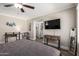 Comfortable bedroom with a ceiling fan, wood-style flooring, and ensuite bathroom at 1708 E Impala Ave, Mesa, AZ 85204
