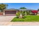 Inviting single-story home featuring a well-kept lawn and a two-car garage at 1708 E Impala Ave, Mesa, AZ 85204