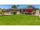 Charming brick home with a well-manicured lawn and beautiful landscaping at 1708 E Impala Ave, Mesa, AZ 85204