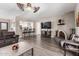 Open-concept living room with stylish wood floors, a fireplace, and modern furnishings at 1708 E Impala Ave, Mesa, AZ 85204