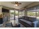 Living room showcasing a sofa, rug, and access to the backyard and outdoor space at 1708 E Impala Ave, Mesa, AZ 85204
