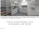 Well-organized laundry room with ample shelving and storage cabinets, plus patterned tile floor at 17205 W Northern Ave, Waddell, AZ 85355