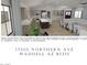 Open-concept living room with a large sectional sofa and access to the kitchen and dining area at 17205 W Northern Ave, Waddell, AZ 85355