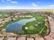 Scenic aerial view featuring a meticulously landscaped golf course and serene lake surrounded by beautiful homes at 175 E Santa Lucia Ln, Queen Creek, AZ 85140
