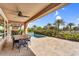 Inviting back patio with a dining table, pool view, mature trees, and covered seating at 175 E Santa Lucia Ln, Queen Creek, AZ 85140