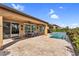 Inviting backyard with pool, covered patio, travertine pavers, and mature landscaping at 175 E Santa Lucia Ln, Queen Creek, AZ 85140