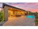 Twilight shot of backyard with pool, patio, dining area and desert landscaping at 175 E Santa Lucia Ln, Queen Creek, AZ 85140