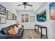Cozy basement featuring a comfy sofa, large screen television, custom shelving, and stylish decor at 175 E Santa Lucia Ln, Queen Creek, AZ 85140