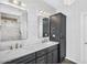 Elegant bathroom with dual sinks, marble countertops, gray cabinets, and modern lighting fixtures at 175 E Santa Lucia Ln, Queen Creek, AZ 85140