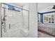 Bright bathroom with white marble shower, glass enclosure, and view into the main bedroom at 175 E Santa Lucia Ln, Queen Creek, AZ 85140