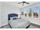 Inviting bedroom with patterned wallpaper, three windows, ceiling fan, and blue accents at 175 E Santa Lucia Ln, Queen Creek, AZ 85140