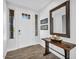 Bright entryway with a white front door, wood-look flooring, console table and decorative mirror at 175 E Santa Lucia Ln, Queen Creek, AZ 85140