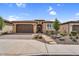 Charming single-story home with a two-car garage, desert landscaping, and a paver walkway at 175 E Santa Lucia Ln, Queen Creek, AZ 85140