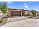 Beautiful single-story home featuring a two-car garage, desert landscaping, and a stone pathway at 175 E Santa Lucia Ln, Queen Creek, AZ 85140