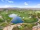 An aerial showcases lush green golf course with scenic water features, sand traps, and mature trees and a wedding venue at 175 E Santa Lucia Ln, Queen Creek, AZ 85140