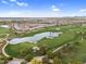 Aerial shot displays a golf course with a lake, sand traps, and manicured greens with upscale community nearby at 175 E Santa Lucia Ln, Queen Creek, AZ 85140