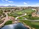 Scenic aerial showing a golf course with lush green fairways, water features, and a pedestrian bridge at 175 E Santa Lucia Ln, Queen Creek, AZ 85140