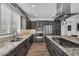 Modern kitchen featuring stainless steel appliances, granite countertops, and dark wood cabinetry at 175 E Santa Lucia Ln, Queen Creek, AZ 85140
