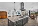 Spacious kitchen island with seating and stainless steel hood range in this open concept home at 175 E Santa Lucia Ln, Queen Creek, AZ 85140