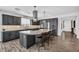 Kitchen island with granite countertops, gray cabinetry, stainless steel appliances, and wood-look tile at 175 E Santa Lucia Ln, Queen Creek, AZ 85140