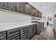 Bright laundry room featuring gray cabinetry, white countertops, stainless steel appliances, and a beverage cooler at 175 E Santa Lucia Ln, Queen Creek, AZ 85140