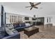 Open-concept living room and kitchen area with a leather sofa and wood-look tile flooring at 175 E Santa Lucia Ln, Queen Creek, AZ 85140