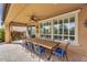 Covered patio featuring a dining table with seating and views of landscaped backyard at 175 E Santa Lucia Ln, Queen Creek, AZ 85140
