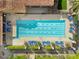 Aerial view of a community pool with blue and white striped lounge chairs and lush landscaping at 175 E Santa Lucia Ln, Queen Creek, AZ 85140
