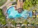 Aerial view of a resort-style pool surrounded by palm trees and lounge areas, perfect for relaxation at 175 E Santa Lucia Ln, Queen Creek, AZ 85140