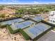 Aerial view of community tennis courts, playground, and green spaces surrounded by well-maintained residential buildings at 175 E Santa Lucia Ln, Queen Creek, AZ 85140