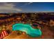 Aerial view showcasing the backyard pool, fire pit area, landscaping, and the surrounding desert landscape at 18438 N 96Th Way, Scottsdale, AZ 85255