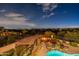 Aerial view captures a backyard with fire pit, pool, pergola, lounge chairs, manicured landscaping, and beautiful views at 18438 N 96Th Way, Scottsdale, AZ 85255