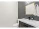 Powder bathroom with geometric backsplash and black sink fixtures at 18438 N 96Th Way, Scottsdale, AZ 85255