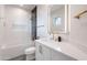 Bathroom featuring a white vanity with gold hardware and a glass-enclosed shower at 18438 N 96Th Way, Scottsdale, AZ 85255