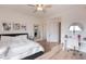 Airy bedroom featuring wood floors, a ceiling fan and a desk with mirror at 18438 N 96Th Way, Scottsdale, AZ 85255