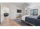 Well-lit bedroom boasts hardwood floors and an en suite visible through an archway at 18438 N 96Th Way, Scottsdale, AZ 85255