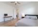 Bedroom with hardwood floors, ceiling fan, and television on table at 18438 N 96Th Way, Scottsdale, AZ 85255
